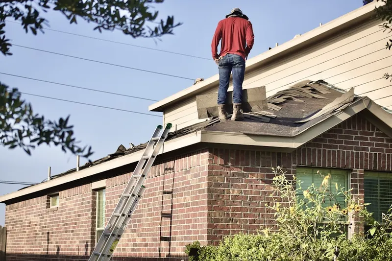 Professional roofer working on a residential roof in East Islip